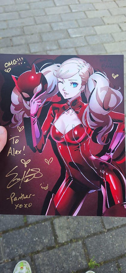 A print of Ann Takamaki from Persona 5, signed by her English voice actress
Erika Harlacher